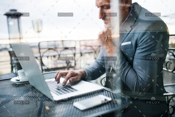 demo-attachment-33-Mature-businessman-with-laptop-outside-a-cafe.